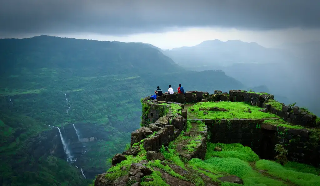 Trekking through lush green hills of Lonavala during rain